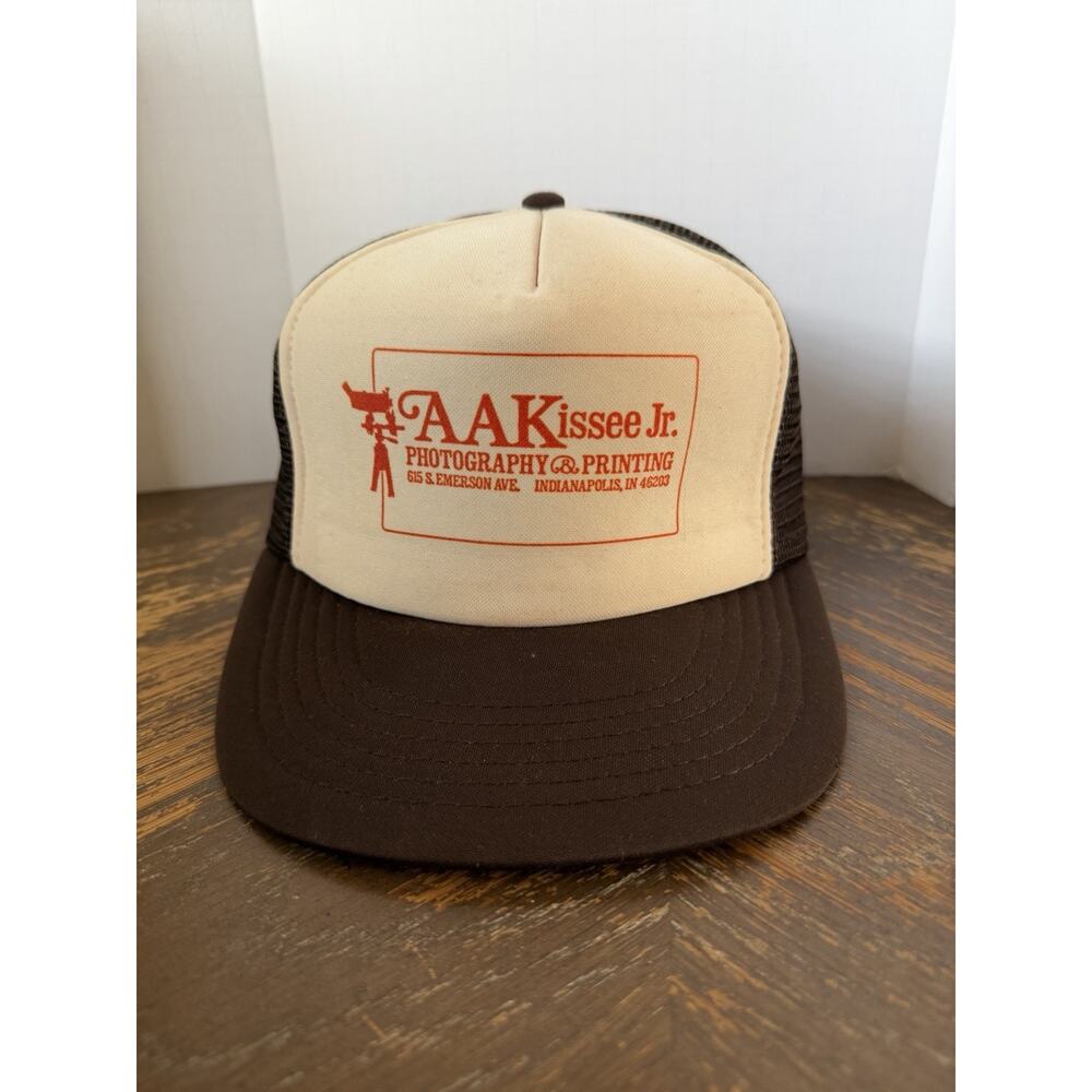 vintage brown and white trucker hat features a custom printed patch for AAKissee